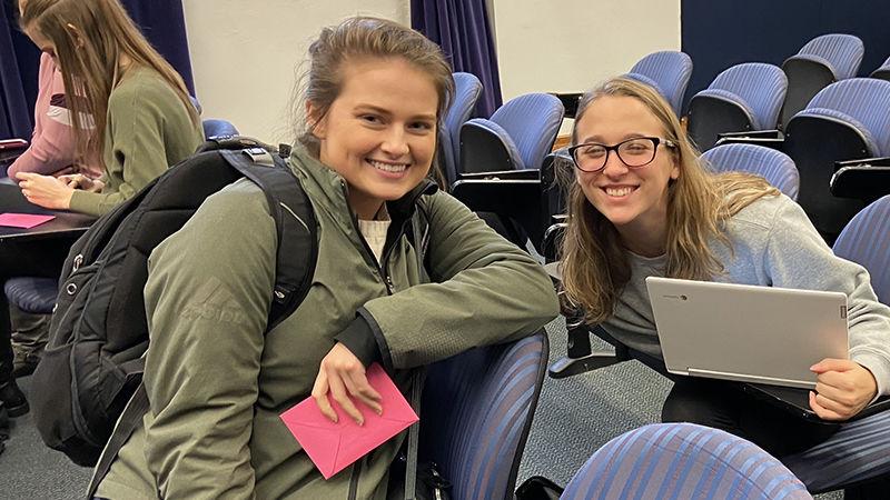 Female students collaborate in auditorium