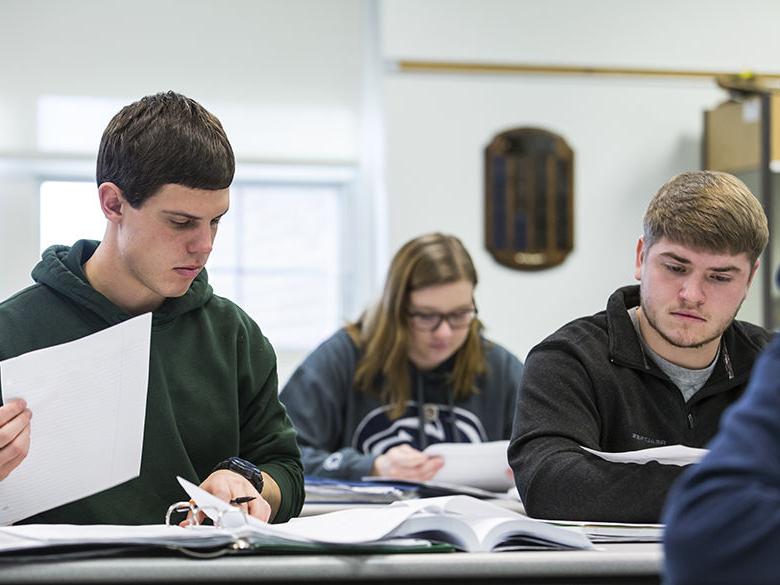 Students study notes in class