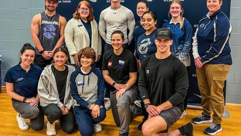 Group photo of faculty and students in front of Penn State Mont Alto athletics banner after the Functional Movement Screen.